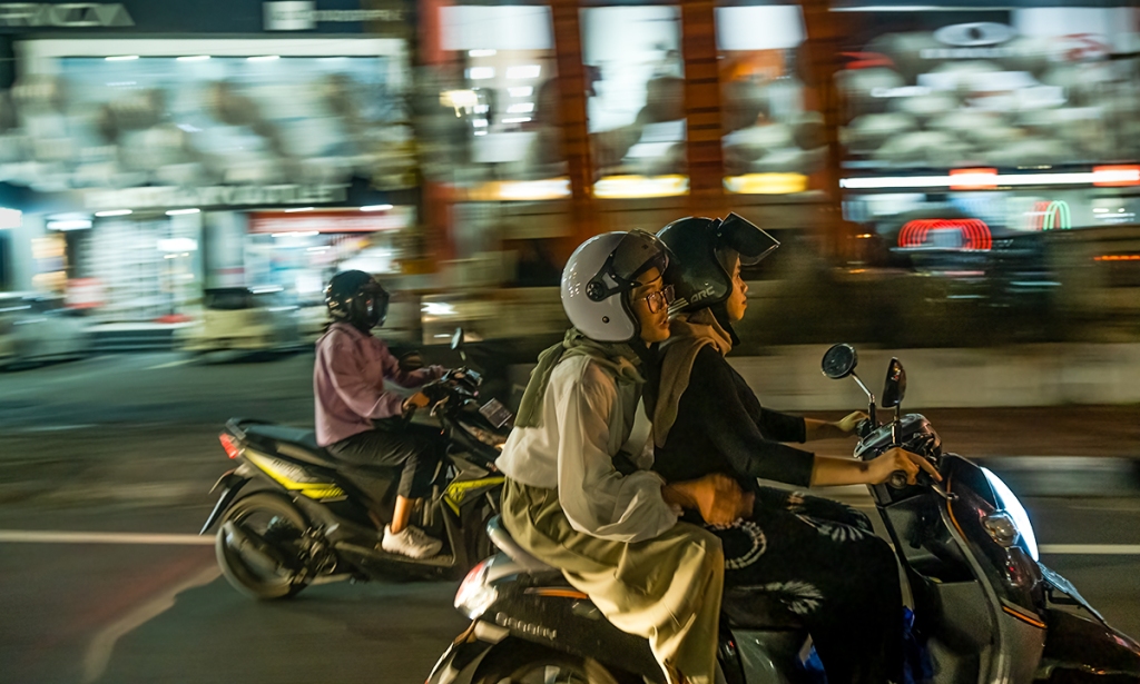 Night Flight, two women on a scooter, Denpasar, Bali, Indonesia